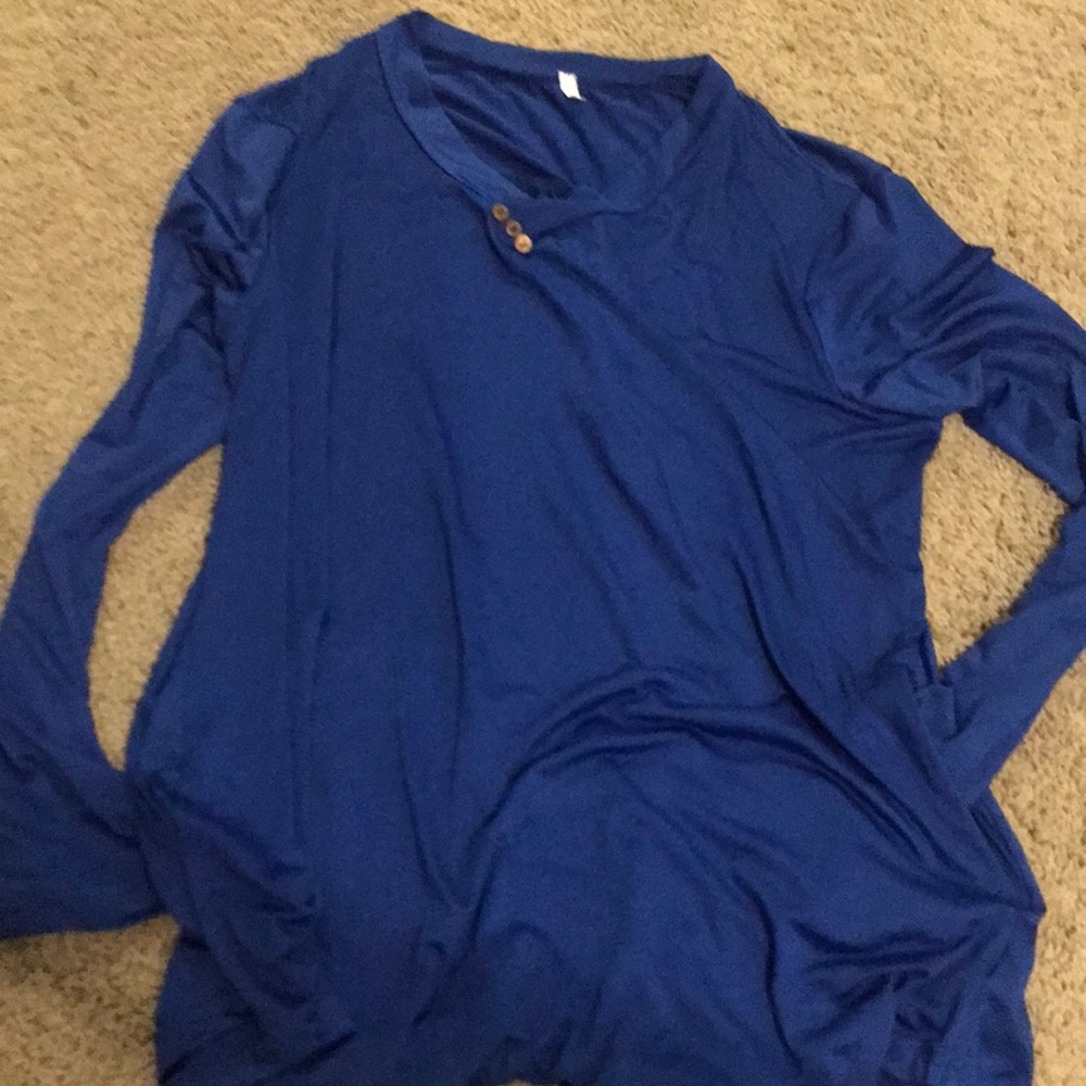 Blue shirt. Long sleeves and has pockets